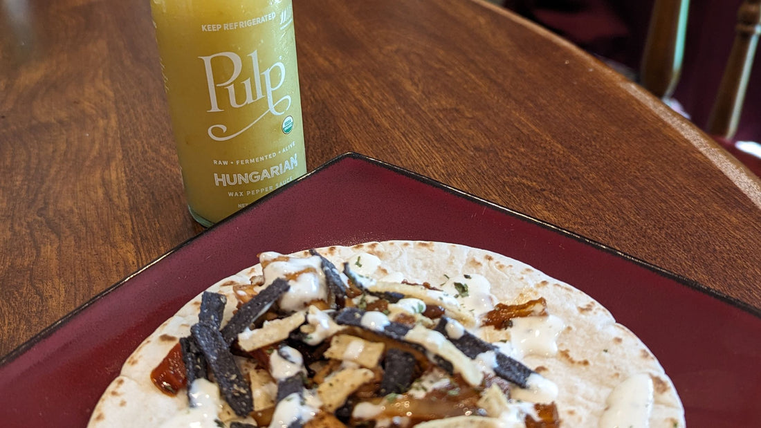 An image of a taco drizzled with Pulp-infused Hungarian Wax Pepper ranch sauce